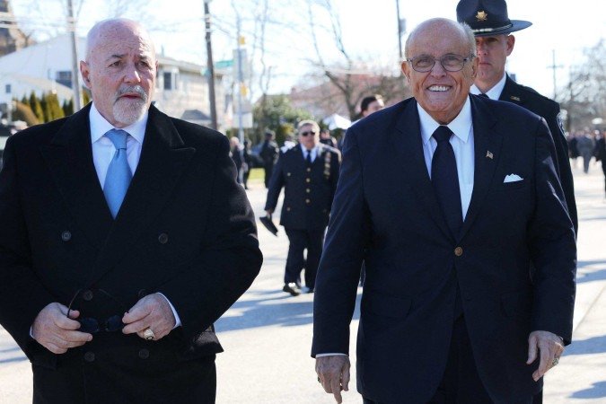  Former NYPD Commissioner Bernard Kerik and former NYC Mayor Rudy Giuliani arrive for the funeral of NYPD officer Jonathan Diller at St. Rose of Lima R.C. Church on March 30, 2024 in Massapequa, New York. Former NYPD Commissioner Bernard Kerik died on May 29, 2025 at the age of 69. In a post on social media, FBI Director Kash Patel said Kerik passed away on Thursday after a private battle with an illness. Kerik was former New York City Mayor Rudy Giulianis commissioner from 2000 to 2001, and served during the 9/11 terrorist attacks. (Photo by Michael M. Santiago / GETTY IMAGES NORTH AMERICA / AFP)       