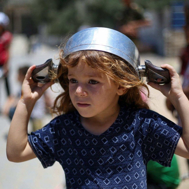  A Palestinian girl arrive at a food distribution point in Nuseirat, central Gaza Strip, June 2, 2025. Israel has faced growing condemnation over the humanitarian crisis in the war-ravaged Gaza Strip, where the United Nations has warned the entire population faces the risk of famine after no aid was allowed to enter for more than two months. (Photo by Eyad BABA / AFP)       