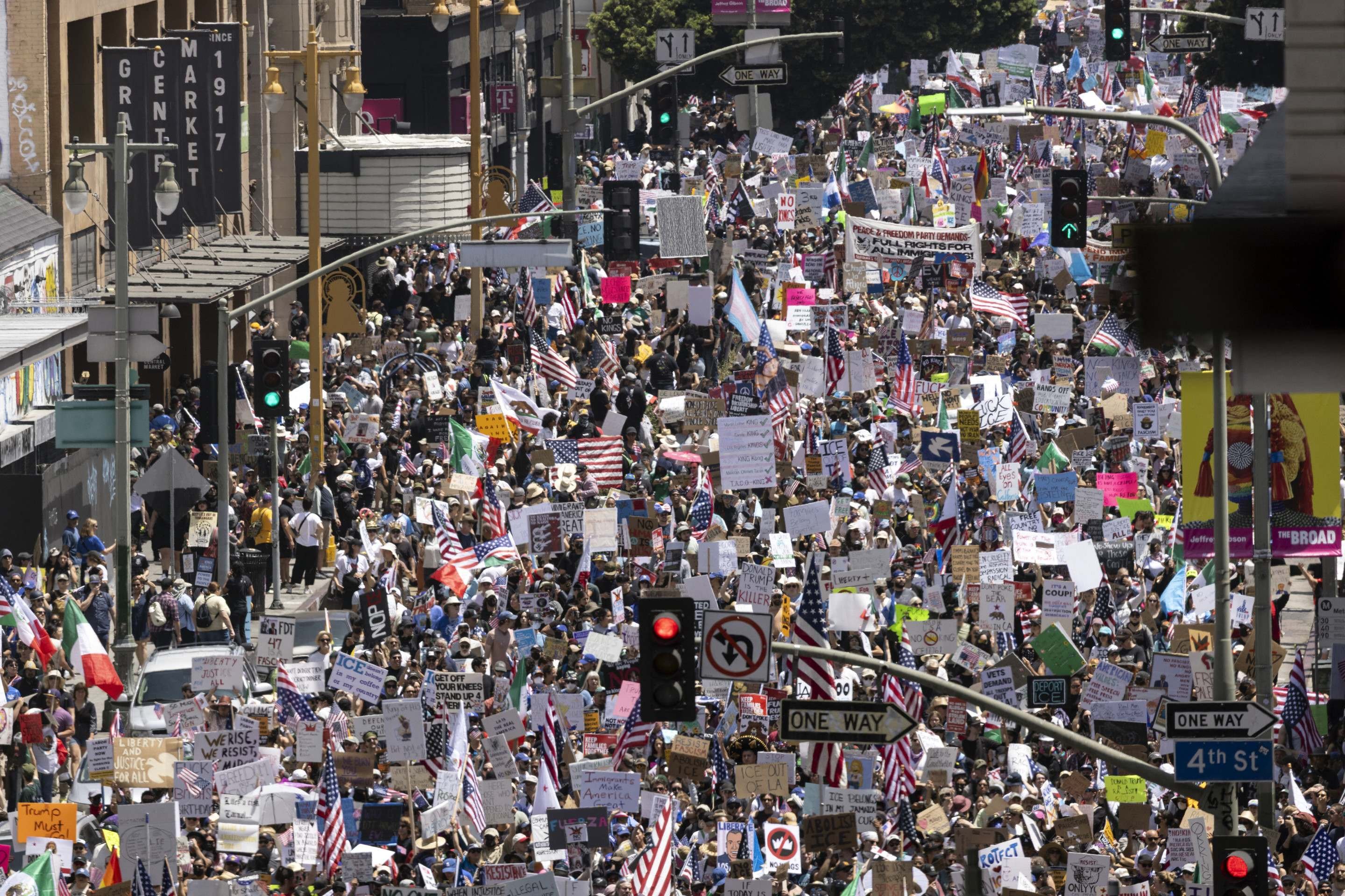  Demonstrators fill the streets as they protest the Trump administration during the 