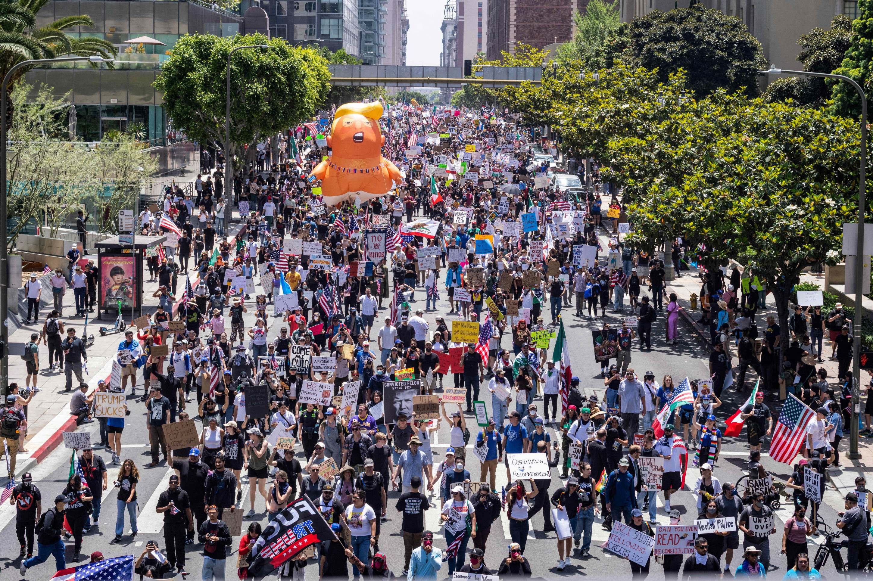  Protesters march with a Donald Trump baby balloon during a nationwide 