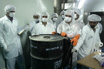  (FILES) Iranian technicians remove a container of radioactive uranium, 'yellow cake', sealed by the International Atomic Energy Agency, to be used at the Isfahan Uranium Conversion Facilities (UCF), 420 kms south of Tehran, on August 8, 2005. Israel unleashed a wave of strikes on Iran on June 13, hitting about 100 targets including nuclear facilities and military command centres, and killing senior figures, among them the armed forces chief and top nuclear scientists. (Photo by Behrouz MEHRI / AFP)
      