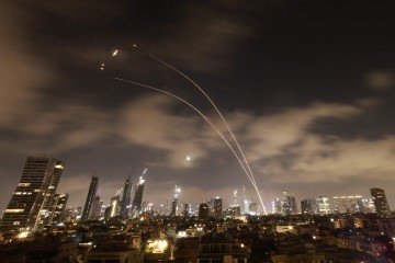 Os sistemas de defesa aérea israelenses são ativados para interceptar mísseis iranianos sobre a cidade israelense de Tel Aviv na manhã de 18 de junho de 2025. -  (crédito: Menahem Kahana / AFP)