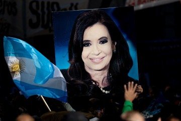  A supporter holds a portrait of former Argentina's President Cristina Fernandez outside her residence in Buenos Aires on June 18, 2025. Argentina's ex-president Cristina Kirchner began serving a six-year fraud sentence under house arrest on Tuesday, after a judge granted her request to avoid prison in a case that dramatically ended her two-decade career. (Photo by TOMAS CUESTA / AFP)
      