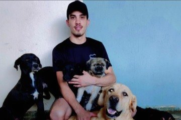 Diego Martins com 2 de seus 5 cachorros adotados