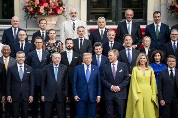  NATO country leaders, Turkey's President Recep Tayyip Erdogan (3rdL), US President Donald Trump (4thL), France's President Emmanuel Macron (R), NATO Secretary General Mark Rutte  (Rear R) pose with King Willem-Alexander (C-L) and Queen Maxima (C-R) of the Netherlands for a family photo as they attend a social dinner at the 'Huis ten Bosch' Royal Palace during a North Atlantic Treaty Organization (NATO) Heads of State and Government summit in The Hague, on June 24, 2025. NATO leaders hold a two-day summit on June 24 and 25 in The Hague. (Photo by Haiyun Jiang / POOL / AFP)
      