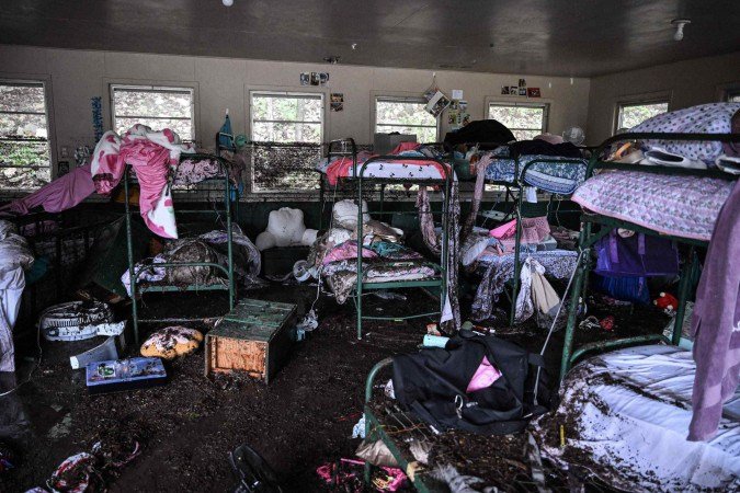 Alojamento do Camp Mystic tomado pela lama: água invadiu o local e arrastou crianças durante a madrugada de sexta-feira - (crédito: Ronaldo Schemidt/AFP) Alojamento do Camp Mystic tomado pela lama: água invadiu o local e arrastou crianças durante a madrugada de sexta-feira - (crédito: Ronaldo Schemidt/AFP)