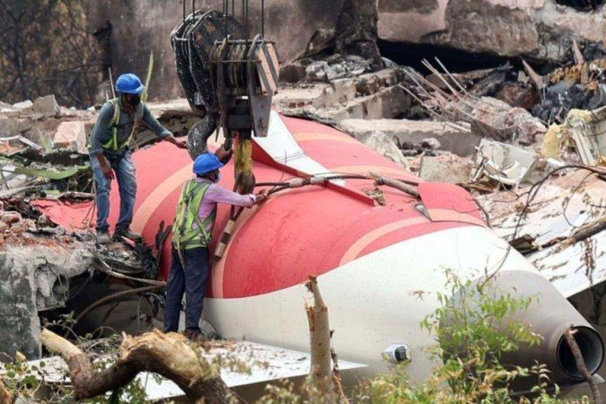 Mulheres lamentam enquanto esperam pelos restos mortais de um parente que faleceu no acidente - (crédito: Getty Images) Mulheres lamentam enquanto esperam pelos restos mortais de um parente que faleceu no acidente - (crédito: Getty Images)