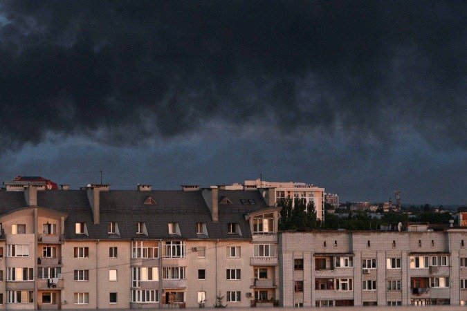  Smoke billows above the citys buildings following mass Russian drone and missile strikes in the western Ukrainian city of Lviv on July 12, 2025, amid the Russian invasion of Ukraine. (Photo by YURIY DYACHYSHYN / AFP)       