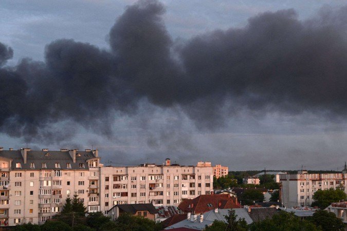  Smoke billows above the citys buildings following mass Russian drone and missile strikes in the western Ukrainian city of Lviv on July 12, 2025, amid the Russian invasion of Ukraine. (Photo by YURIY DYACHYSHYN / AFP)       