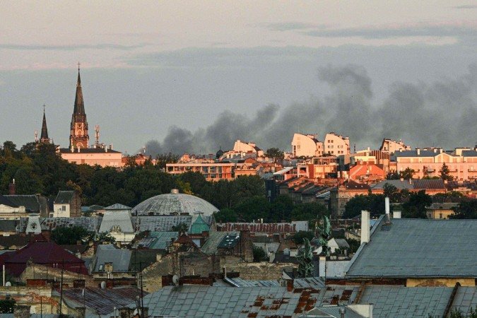  Smoke billows above the citys buildings following mass Russian drone and missile strikes in the western Ukrainian city of Lviv on July 12, 2025, amid the Russian invasion of Ukraine. (Photo by YURIY DYACHYSHYN / AFP)       