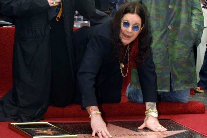 (ARQUIVOS) O roqueiro britânico Ozzy Osbourne (C) posa com os amigos e músicos Marilyn Manson (E) e Robbie Williams (D) durante a cerimônia de inauguração de sua estrela na Calçada da Fama de Hollywood, em 12 de abril de 2002, em Hollywood, Califórnia. Ozzy Osbourne, vocalista da banda de heavy metal Black Sabbath, morreu em 22 de julho de 2025, aos 76 anos, anunciou sua família em um comunicado. "Ele estava com sua família e cercado de amor. Pedimos a todos que respeitem a privacidade da nossa família neste momento", acrescentou o comunicado. (Foto de LEE CELANO / AFP)      