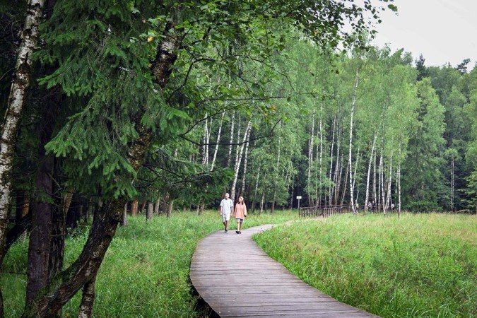  Pedestrians walk in Losiny Ostrov National Park (Elk Island) outside Moscow on August 2, 2025. Russian law prohibits construction in national parks but local authorities got around it by arguing that the project consisted of 