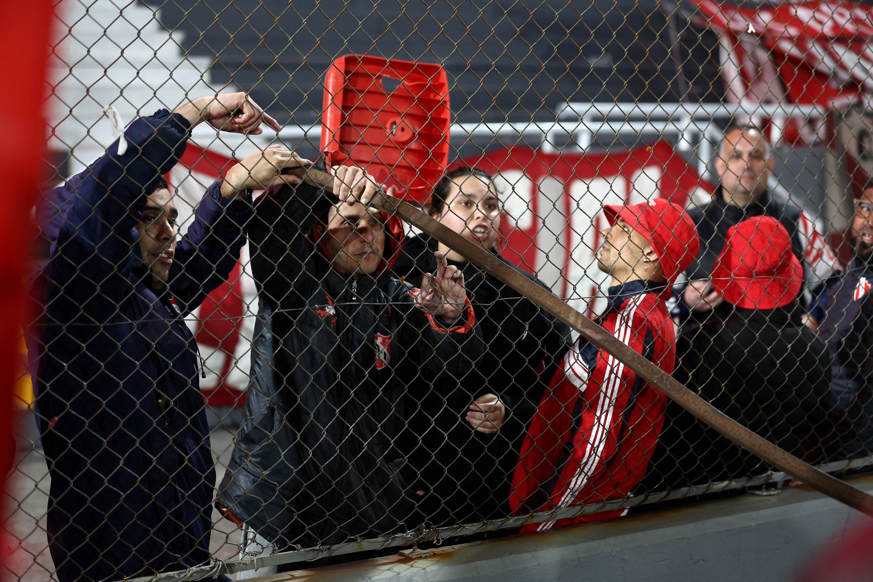 Torcedor do Independiente mostra uma barra de aço durante a interrupção da partida de volta das oitavas de final da Copa Sul-Americana entre o Independiente da Argentina e a Universidad de Chile do Chile no estádio Libertadores da América em Avellaneda, província de Buenos Aires, Argentina, em 20 de agosto de 2025      