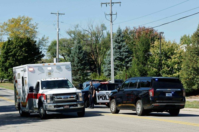  Police and emergency vehicles respond near the scene of a shooting at a church in Grand Blanc, Michigan, on September 28, 2025. One person was killed and several others injured Sunday after a shooter targeted a Mormon church in the US state of Michigan, where the building was also set on fire, authorities said.  The suspect, a 40-year-old man from a nearby town, was shot dead by law enforcement after the attack, police said, without specifying any possible motive. (Photo by Jeff Kowalsky / AFP)       