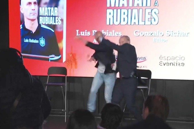 O agressor invadiu o espaço do evento e lançou ovos em direção a Rubiales enquanto o chamava de O agressor invadiu o espaço do evento e lançou ovos em direção a Rubiales enquanto o chamava de