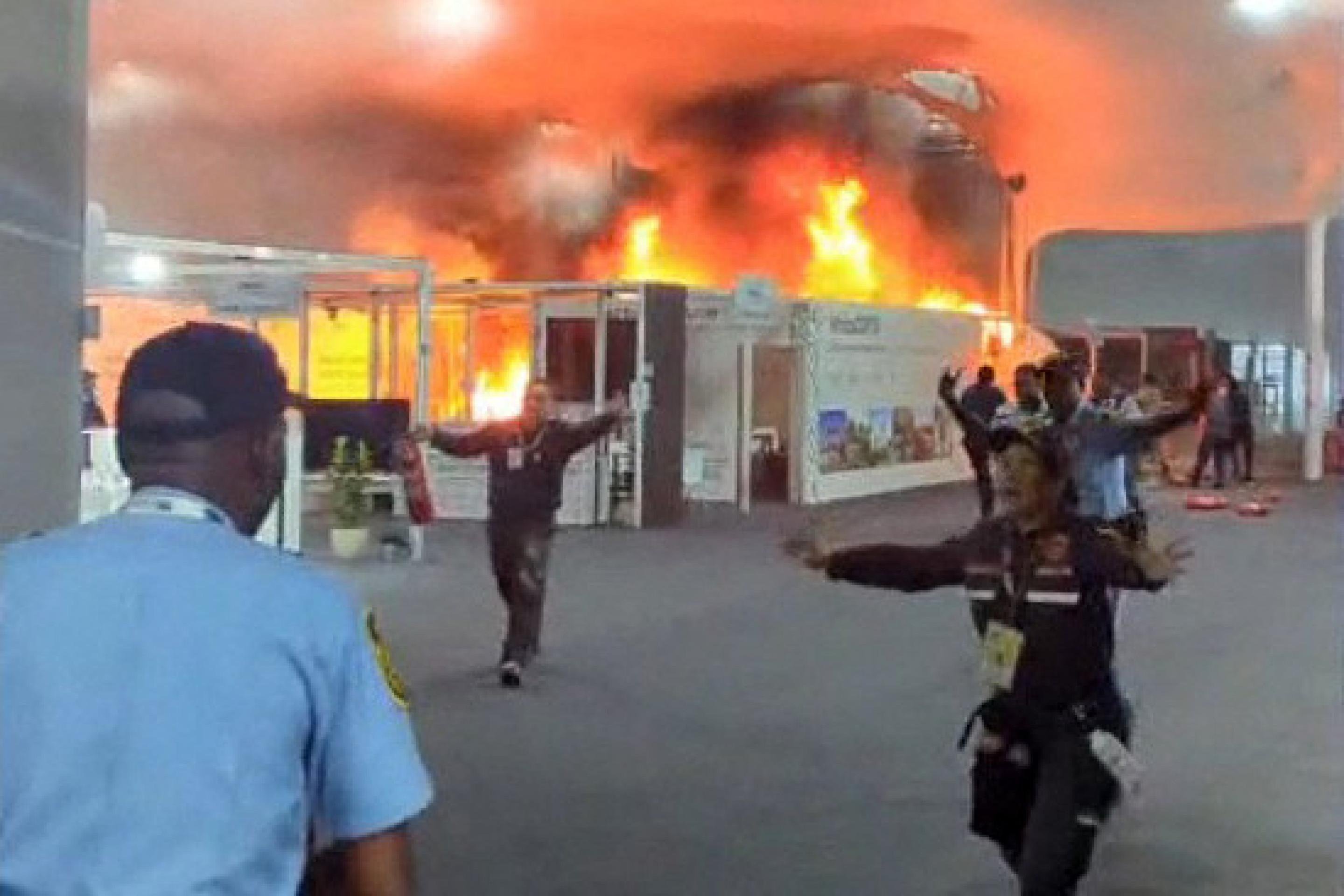  This screen grab taken from AFPTV video footage shows emergency crews battling a fire that broke out at a pavilion inside the venue of the COP30 UN Climate Change Conference in Belem, Para state, Brazil, on November 20, 2025. A fire erupted at a pavilion inside the venue of the UN's climate talks in Brazil on Thursday, prompting panicked delegates to run for the exits, AFP journalists said. Emergency crews rushed to try to put out the blaze as smoke engulfed the corridor. (Photo by AFPTV / AFP)
      