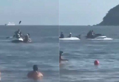 Vídeo gravado por banhista mostra momento em que o casal remava de caiaque quando foi abordado por dupla em jet ski -  (crédito: Reprodução/X) -Vídeo gravado por banhista mostra momento em que o casal remava de caiaque quando foi abordado por dupla em jet ski -  (crédito: Reprodução/X)