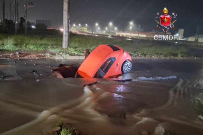 Socorristas encontraram o carro dentro de uma vala formada no meio da pista - (crédito: CBMDF/Divulgação) Socorristas encontraram o carro dentro de uma vala formada no meio da pista - (crédito: CBMDF/Divulgação)
