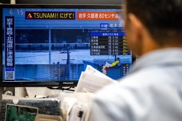 Mensagem de alerta em uma tela de uma transmissão ao vivo da NHK com um aviso de tsunami após um terremoto atingir o norte do Japão, em Tóquio, em 20 de abril de 2026. -  (crédito:  AFP)