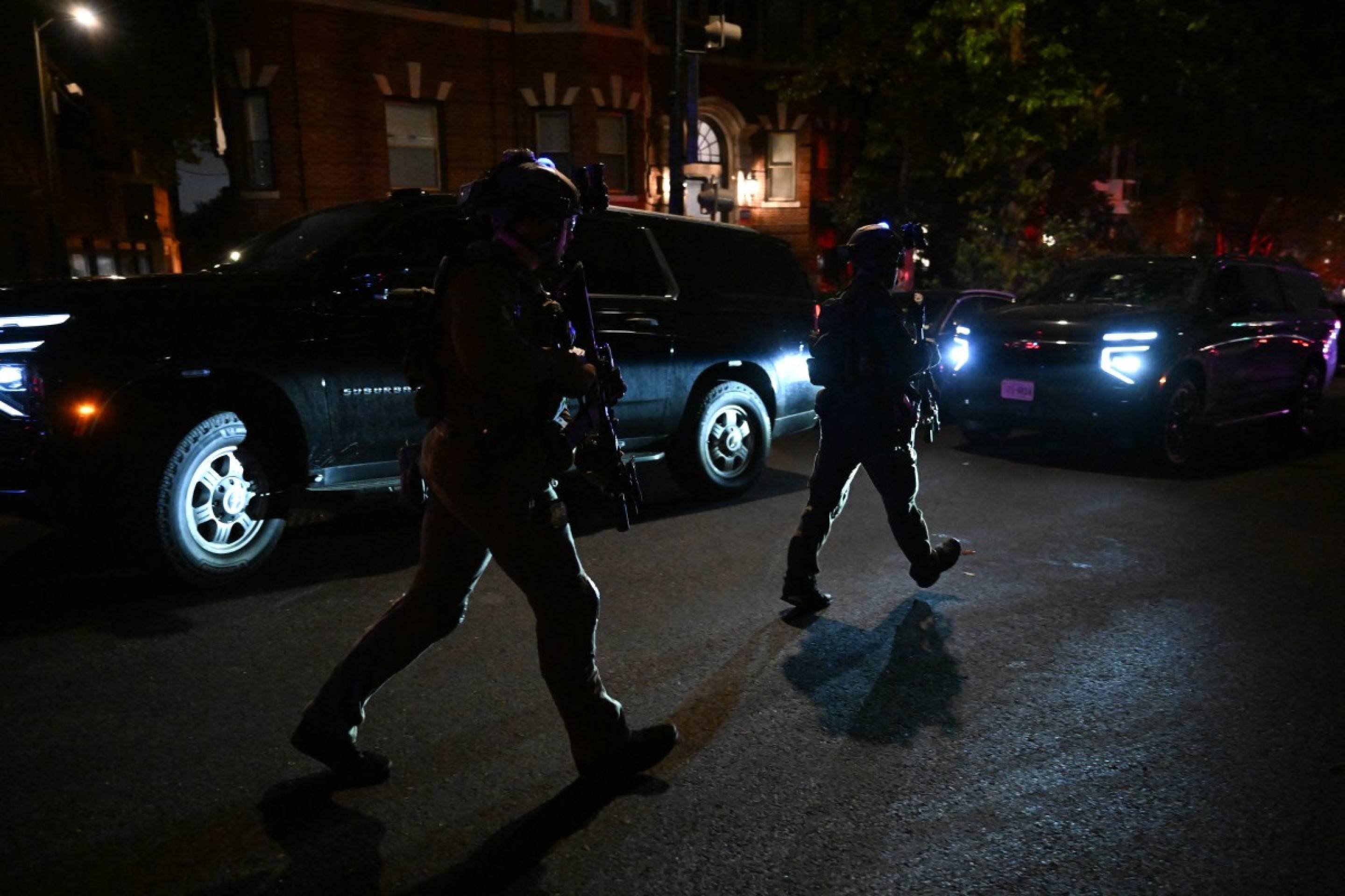  Commandos secure a street as they prepare to escort a convoy of special guests after shots were reportedly fired during the White House Correspondents' dinner at the Washington Hilton in Washington, DC, on April 25, 2026. Shots were allegedly fired as US President Donald Trump attended a press dinner in Washington on Saturday night, witnesses and AFP reporters said as loud bangs were heard at the hotel venue. (Photo by Roberto Schmidt / AFP)
      
