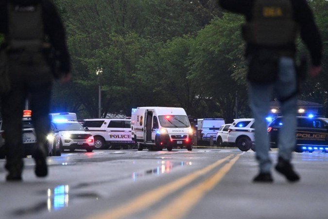  Police vehicles are seen on a blocked street near a crime scene not far from the White House in Washington, DC, on May 23, 2026. Police and security forces swarmed the area around the White House on the evening of May 23 after reports of shots fired, AFP journalists said. US President Donald Trump was at the White House at the time as he worked to negotiate a deal with Iran. (Photo by Alex WROBLEWSKI / AFP)
      