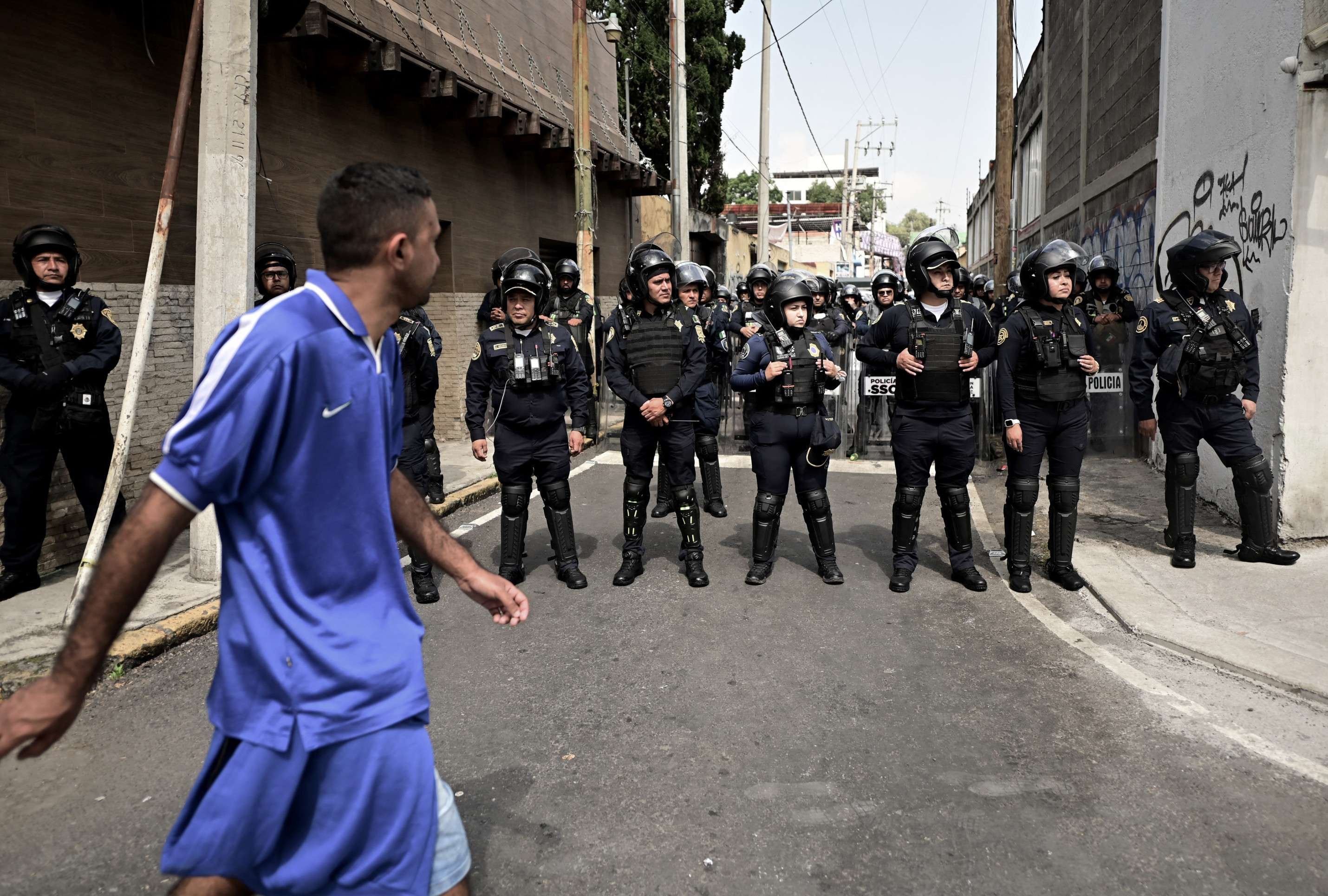  Police block a street to prevent protesting members of the 