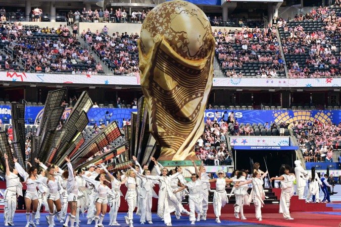 Pela primeira vez na história, o Mundial contou com três aberturas, uma em cada país sede - (crédito: FREDERIC J. BROWN / AFP) Pela primeira vez na história, o Mundial contou com três aberturas, uma em cada país sede - (crédito: FREDERIC J. BROWN / AFP)