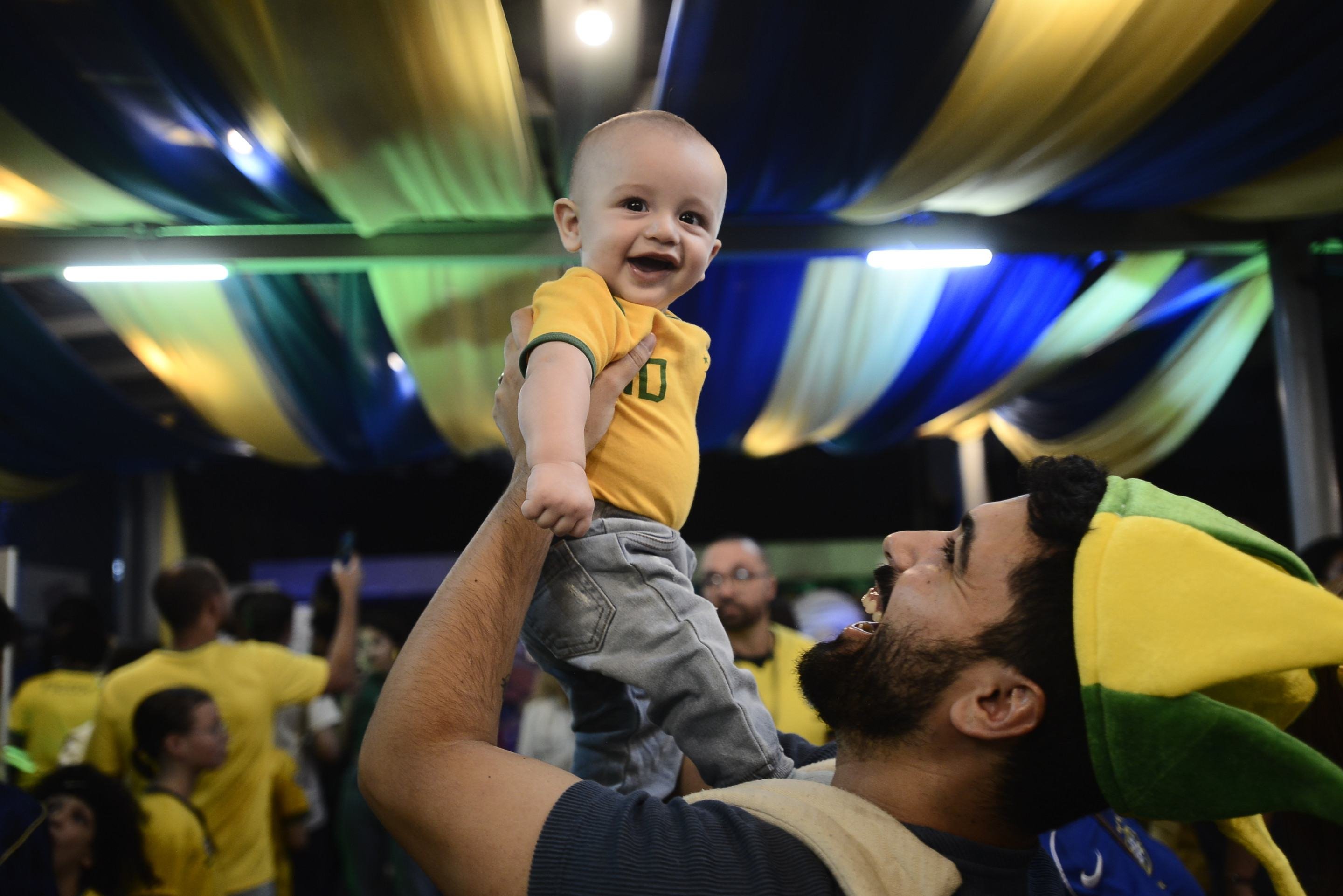 Gabriel Zimer ergue o filho Murilo, 8 meses, estreando em Copas