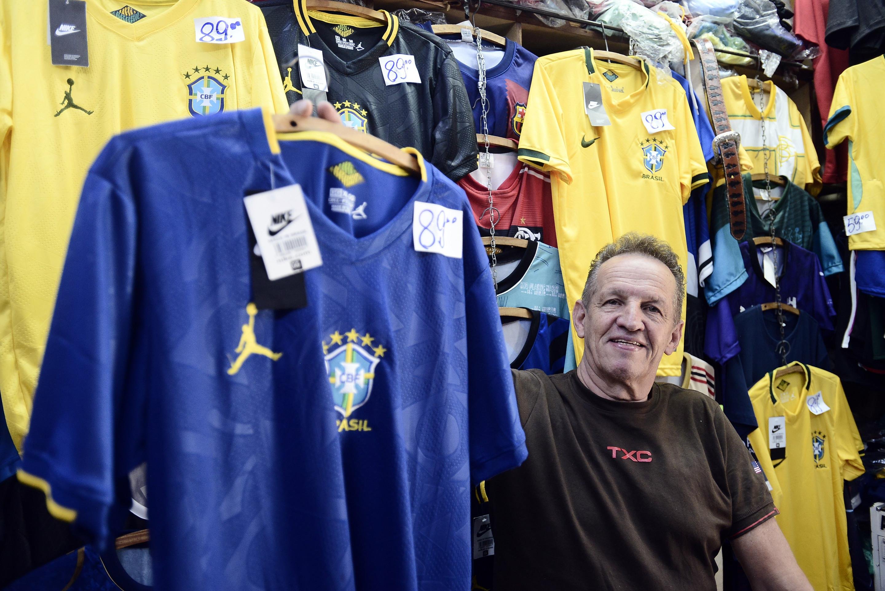 Dono da Plabier Modas do Mercado Norte, Placídio de Assis, conta que as vendas estão melhores em relação à Copa de 2022 30/06/2026. A caçada á camisa oficial (e as réplicas) e aos adereços para torcer pelo Brasil na Copa. Placídio de Assis Foto: Minervino Júnior