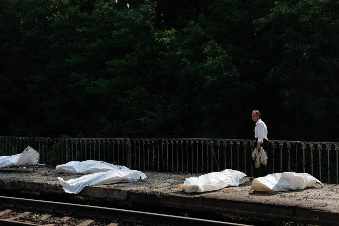 Homem caminha diante de corpos armazenados em sacos mortuários, em estação ferroviária de Kiev: civis na linha de fogo dos bombardeios - (crédito: Mykola Tymchenko/AFP)) Homem caminha diante de corpos armazenados em sacos mortuários, em estação ferroviária de Kiev: civis na linha de fogo dos bombardeios - (crédito: Mykola Tymchenko/AFP))
