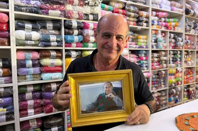 Paulo Milano segurando um retrato de seu pai, Stefano Milano